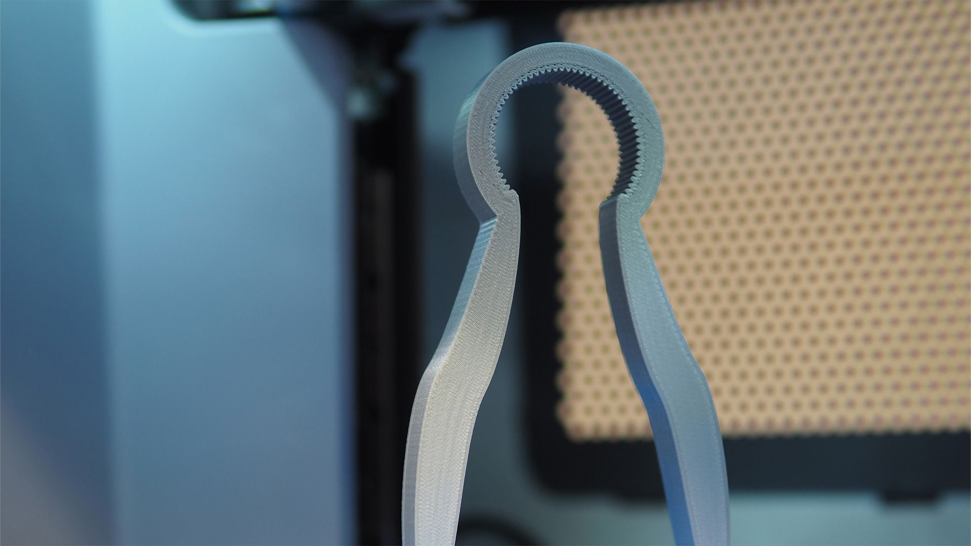 A 3d printed assistive bottle opener inside a 3D printer.