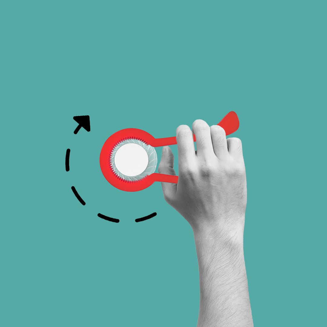 A hand gripping an assistive bottle opener.