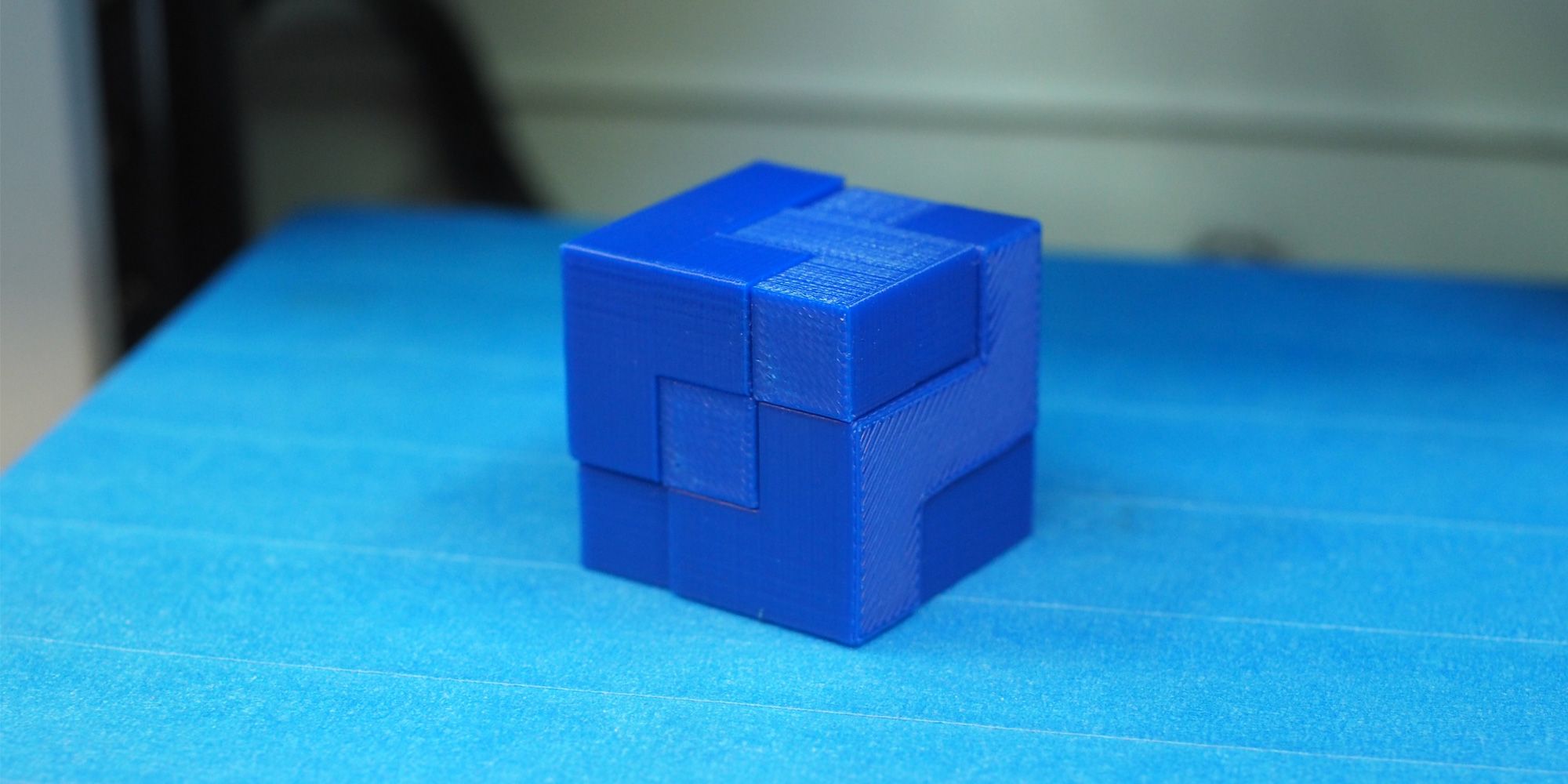 A fully assembled 3D printed puzzle cube on a 3D print bed.