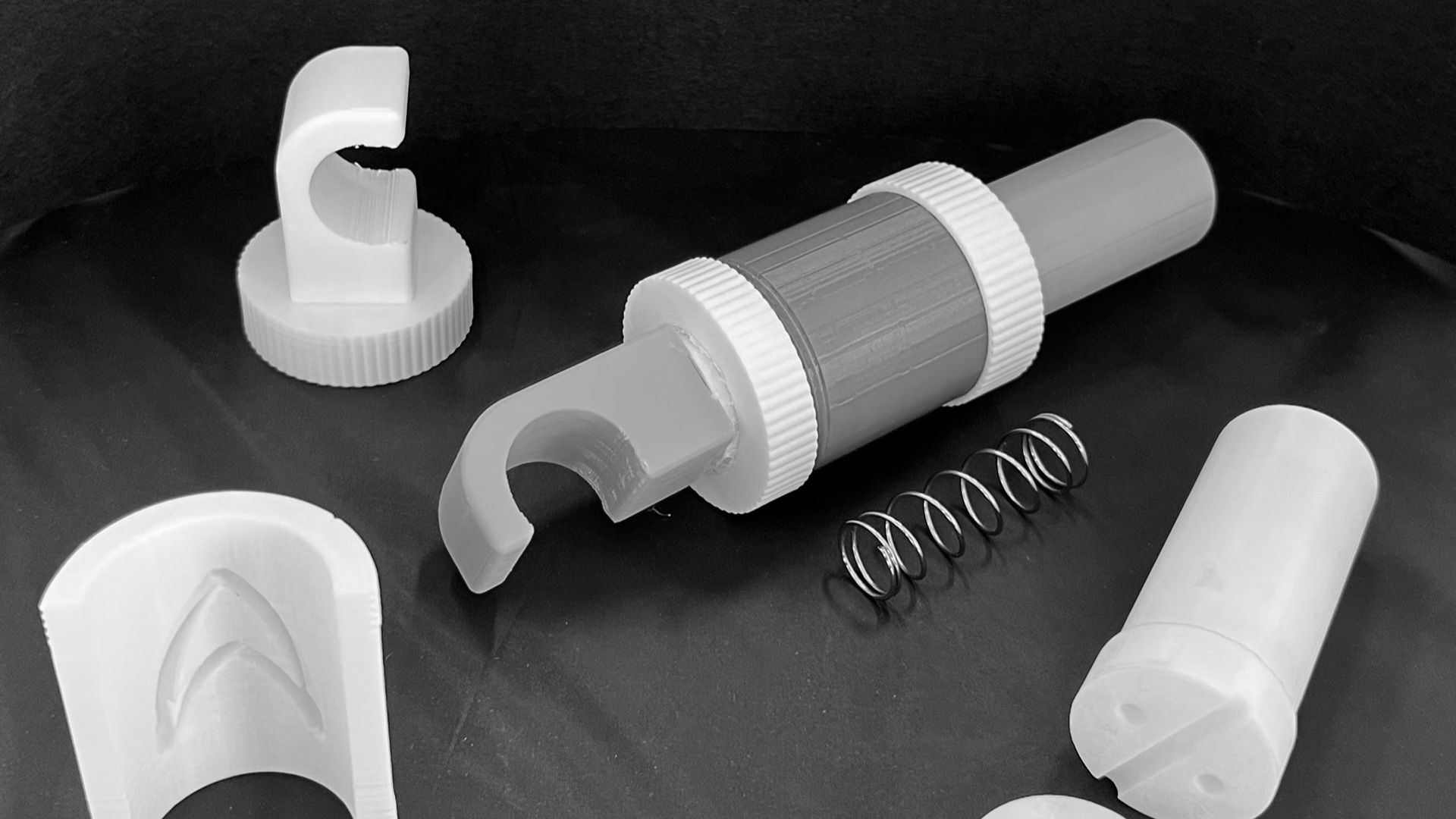 A variety of small 3D printed parts ready to be assembled in to a Make:able assistive device.